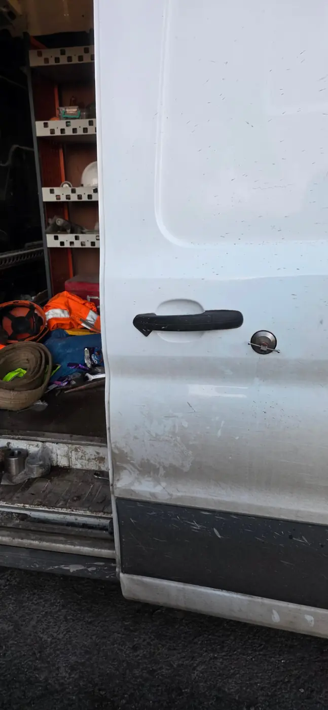 White van side door lock being opened by a mobile locksmith